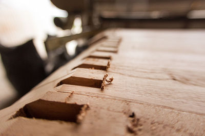 Close-up of incomplete wooden musical instrument at workshop