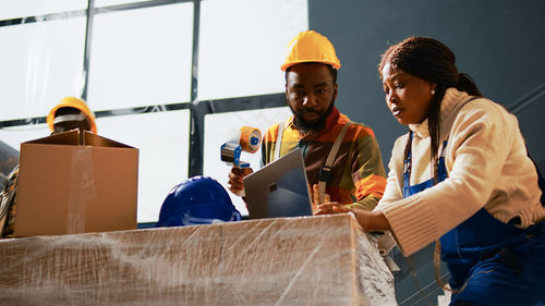 Side view of people working at construction site