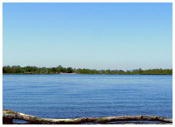 Scenic view of calm sea against clear sky