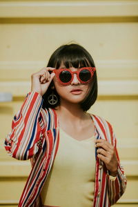 Portrait of woman wearing sunglasses standing outdoors