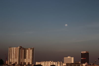 Modern buildings in city against clear sky