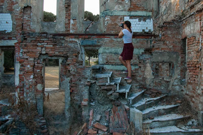 Woman standing in abandoned building