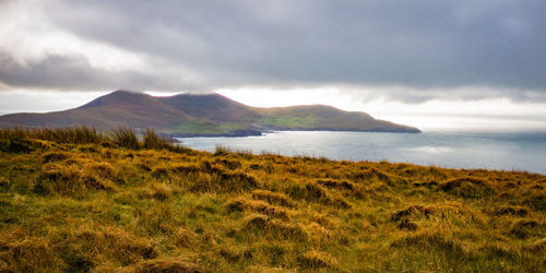 Scenic view of sea and mountains against sky