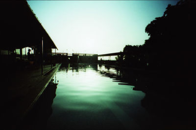 Scenic view of river against clear sky at sunset