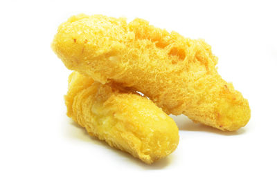 Close-up of bread in plate against white background