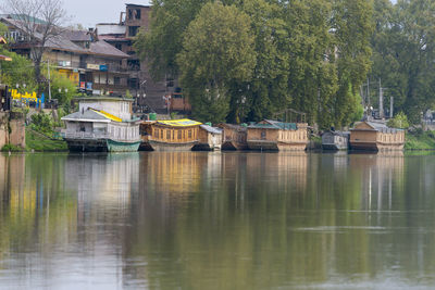 Reflection of trees and buildings in lake