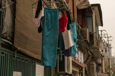 Low angle view of clothes drying outside house