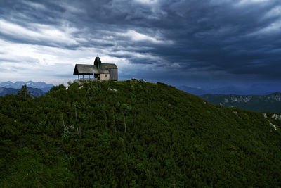 Building on mountain against sky