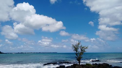 Scenic view of sea against cloudy sky