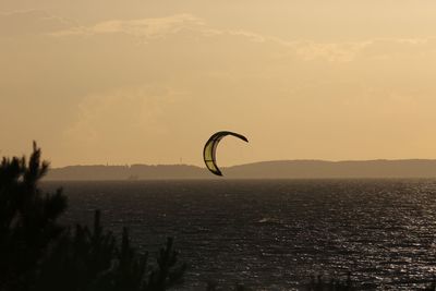 High angle view of parasail over sea against sky during sunset