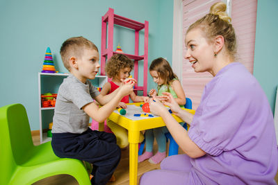 Siblings sitting on table