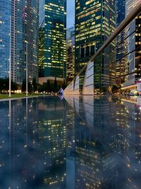 Digital composite image of illuminated modern buildings in city