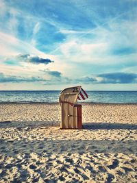 Lifeguard hut on beach against sky