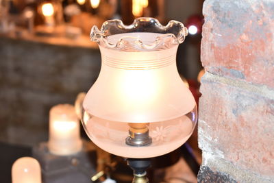 Close-up of illuminated tea light on table