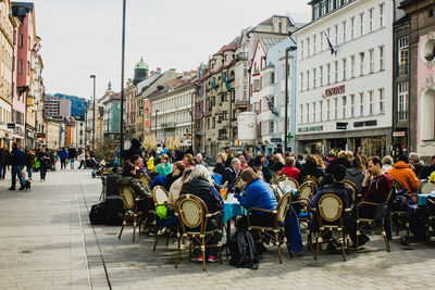 People on street amidst buildings in city