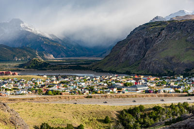 Scenic view of village by houses against mountains