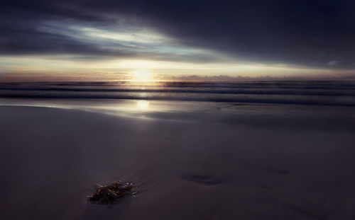 Scenic view of sea against sky at sunset