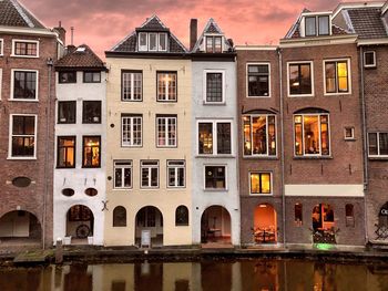 Reflection of building in canal against sky