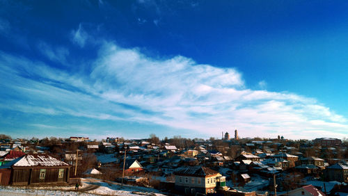 Cityscape against cloudy sky