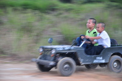 Father and son riding on motorcycle