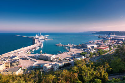 High angle view of sea by buildings against sky