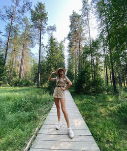 Full length of woman walking on boardwalk