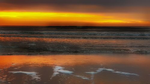 Scenic view of sea against orange sky