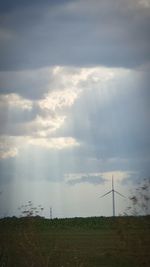 Scenic view of field against cloudy sky