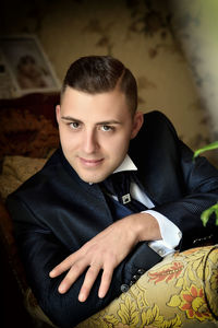 Close-up portrait of man sitting at home