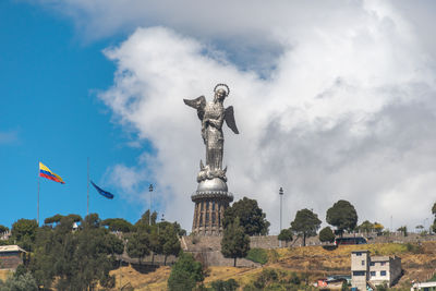 Low angle view of statues on building against sky