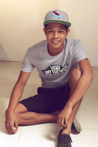 Portrait of young man sitting on table