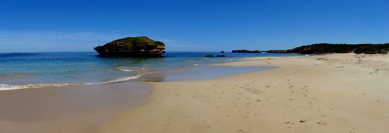 Scenic view of sea against clear blue sky