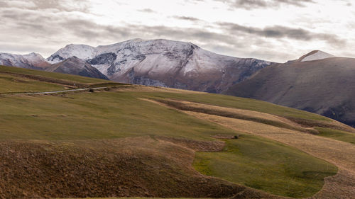 Scenic view of landscape and mountains against sky