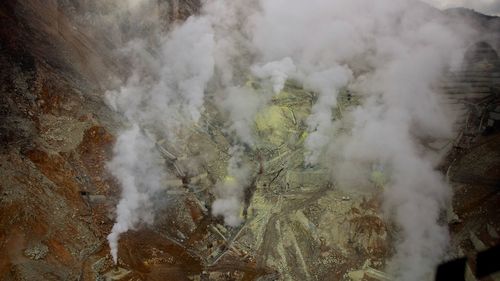 Smoke emitting from volcanic mountain