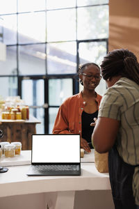 Portrait of woman using laptop at table