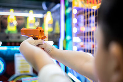 Close-up of hand holding illuminated lighting equipment