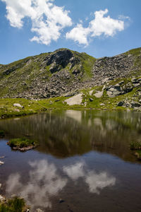 Scenic view of lake and mountains against sky