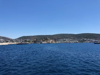 Scenic view of sea against clear blue sky