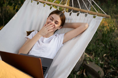 Low angle view of young woman sitting in tent