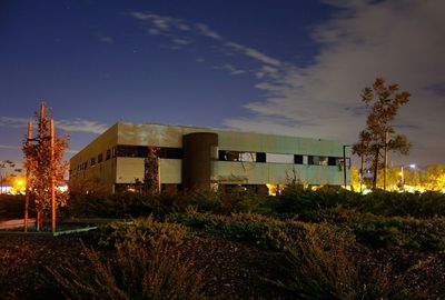 Illuminated street light against sky at night