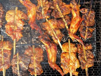 High angle view of meat on barbecue grill