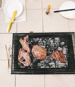 High angle view of meat on barbecue grill