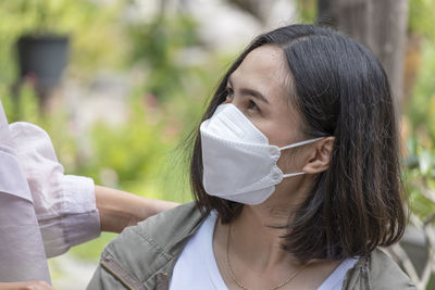 Close-up of young woman wearing hat