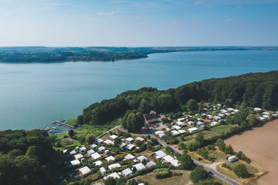 High angle view of townscape by sea against sky