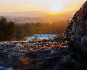 Close-up of rock against sky during sunset