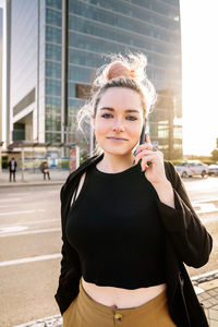 Beautiful young woman on street in city