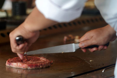 Midsection of man preparing food