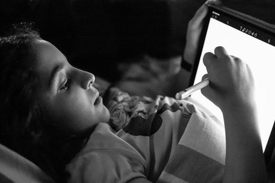 Close-up portrait of woman holding smart phone at home