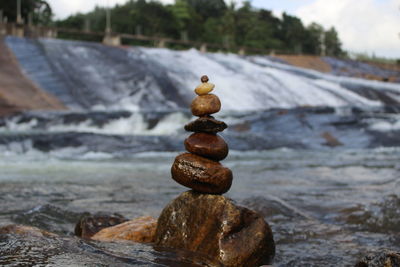 Close-up of stone stack in river
