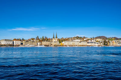 View of sea against buildings in city